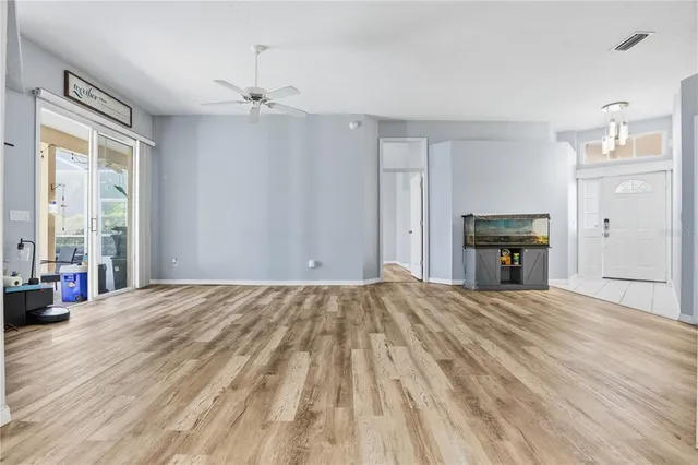 a view of empty room with wooden floor and fireplace