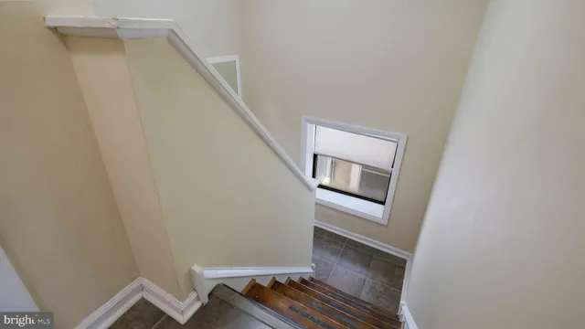 a view of hallway with wooden floor and staircase