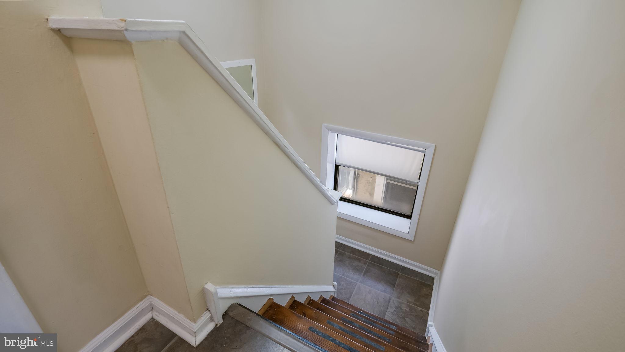2120 South Street, Unit 2RE Philadelphia, PA 19146 - Photo 14 of 20 a view of room with stairs and wooden floor