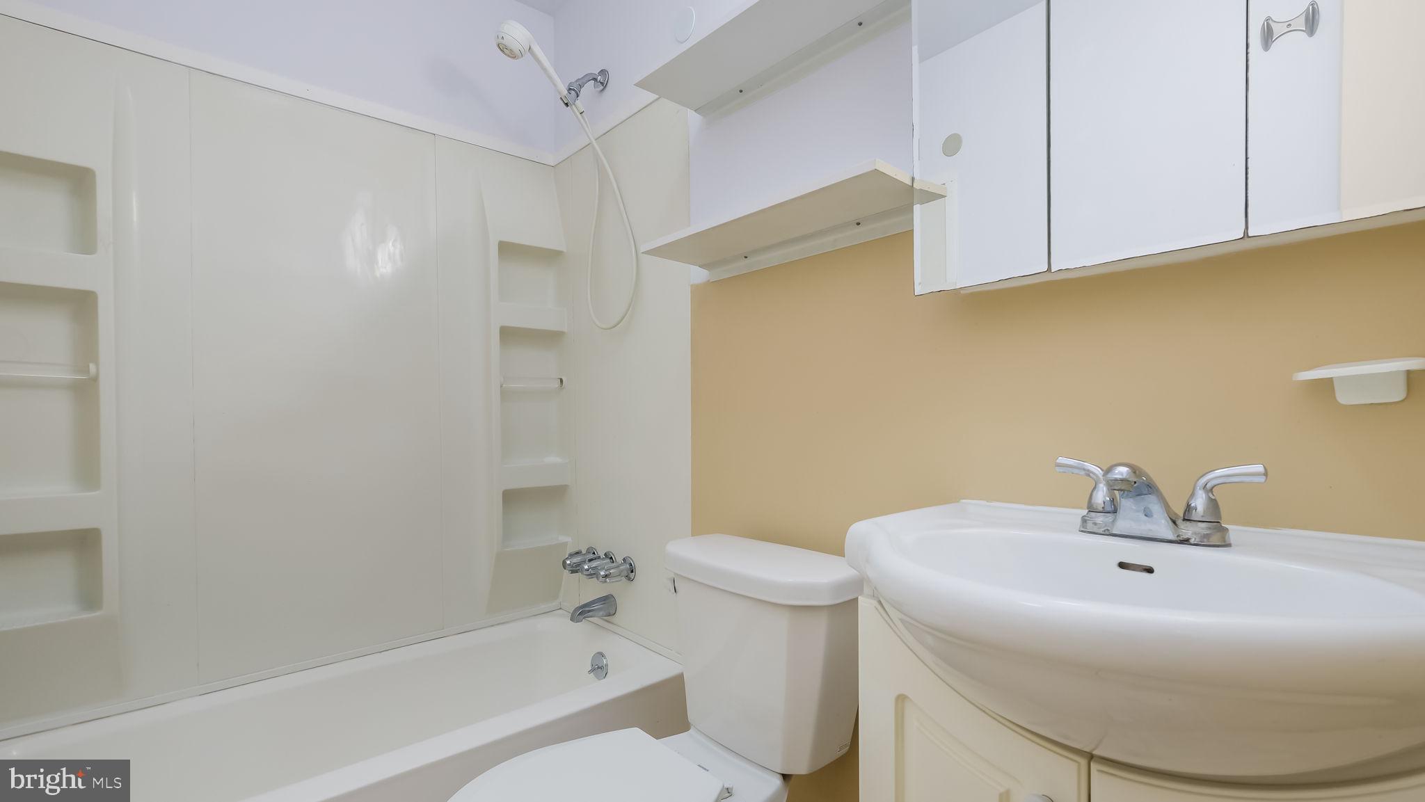 2120 South Street, Unit 2RE Philadelphia, PA 19146 - Photo 19 of 20 a bathroom with a sink a toilet and shower