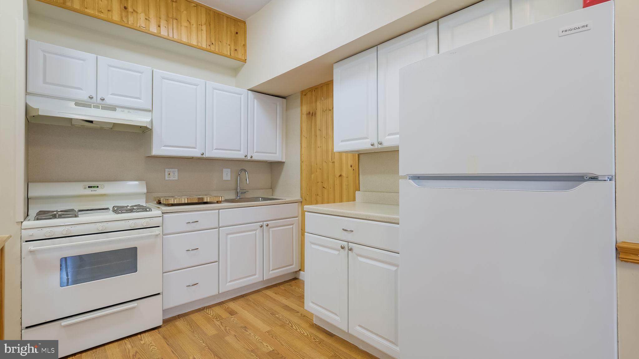 2120 South Street, Unit 2RE Philadelphia, PA 19146 - Photo 5 of 20 a kitchen with cabinets appliances a sink and a window