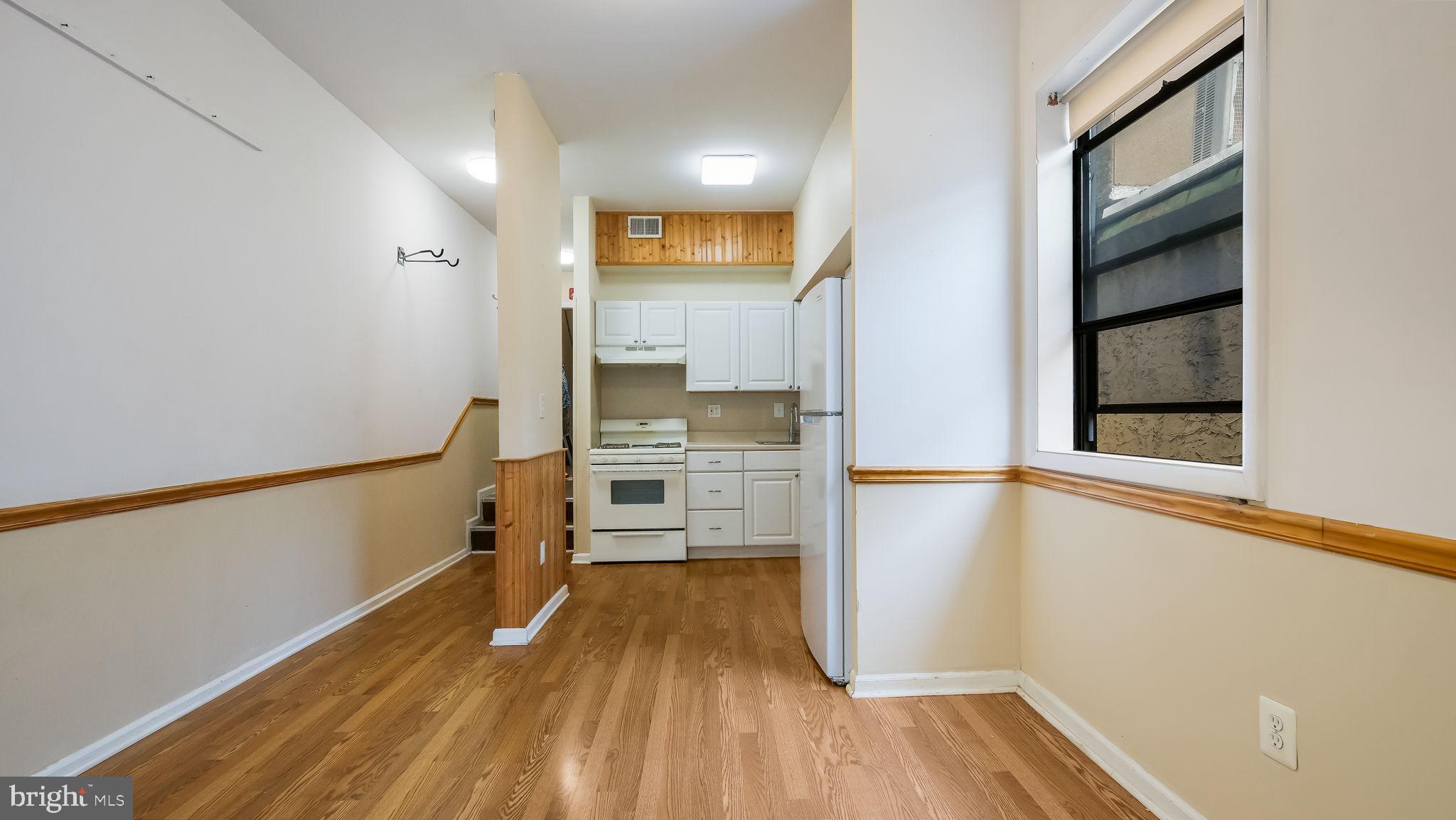 2120 South Street, Unit 2RE Philadelphia, PA 19146 - Photo 9 of 20 a view of a kitchen with wooden floor and a window