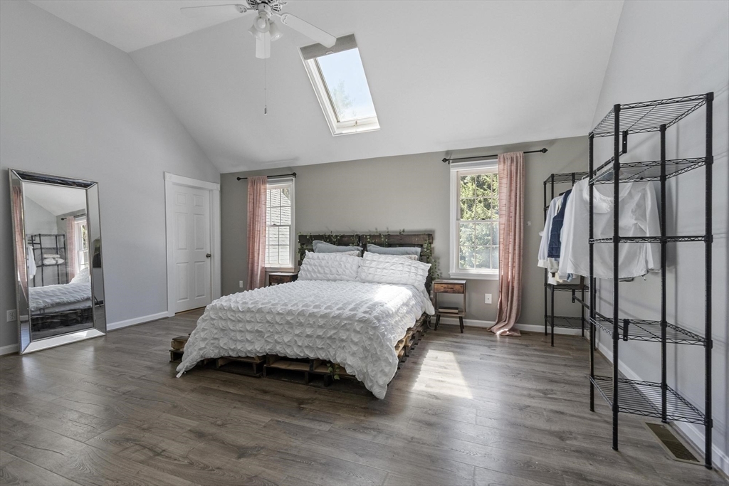 4 Ridge Road Pepperell, MA 01463 - Photo 22 of 42 a bedroom with a bed and wooden floor