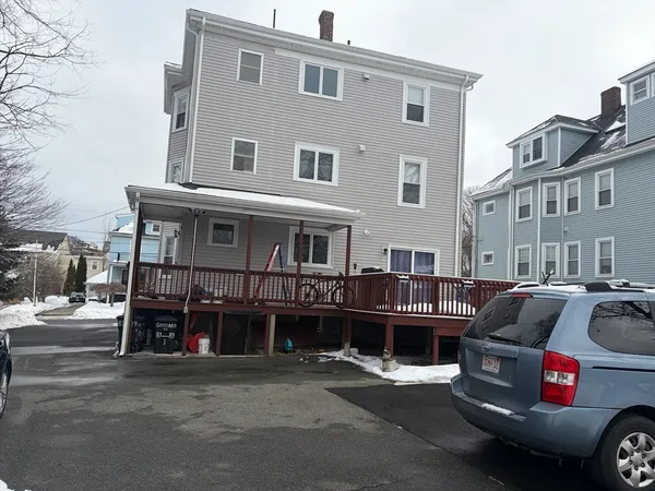 a front view of a house with a parking space