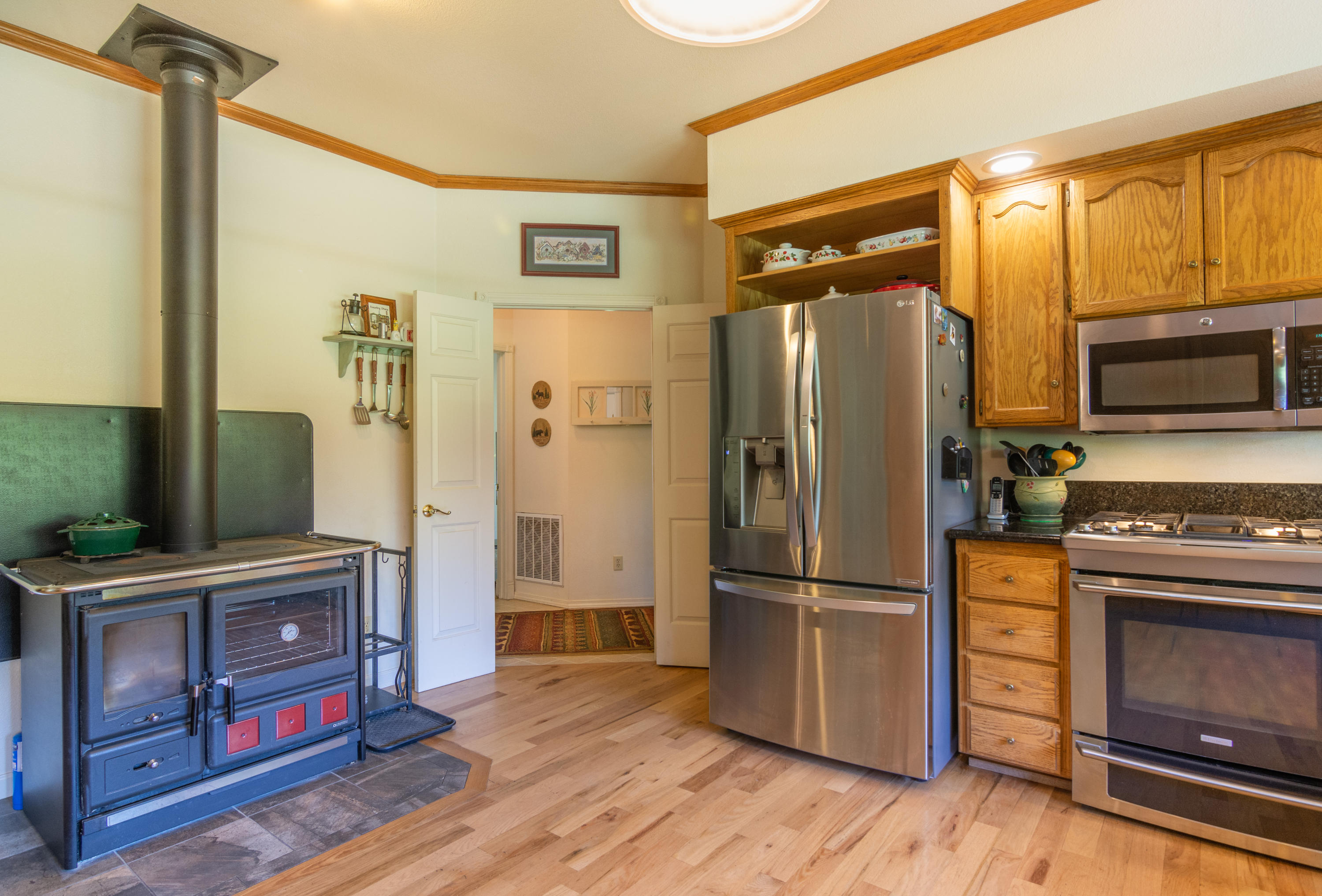 320 Salt Flat Road Lewiston, CA 96052 - Photo 8 of 32 a kitchen with stainless steel appliances granite countertop a refrigerator and a stove top oven