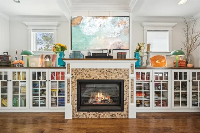 a living room with furniture a fireplace and a window