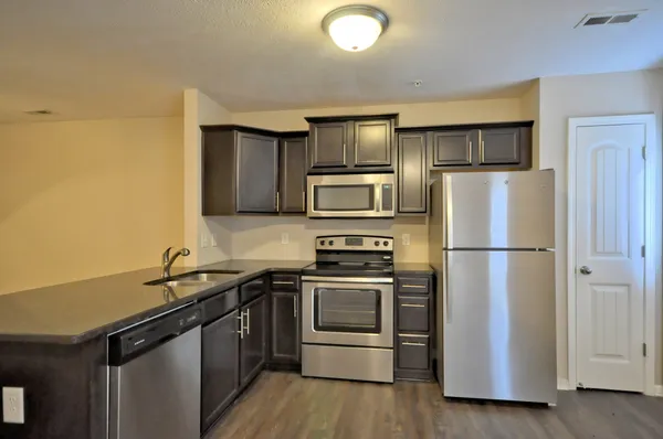 a kitchen with a refrigerator sink and stainless steel appliances