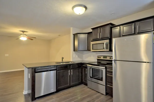 a kitchen with stainless steel appliances a refrigerator and a sink