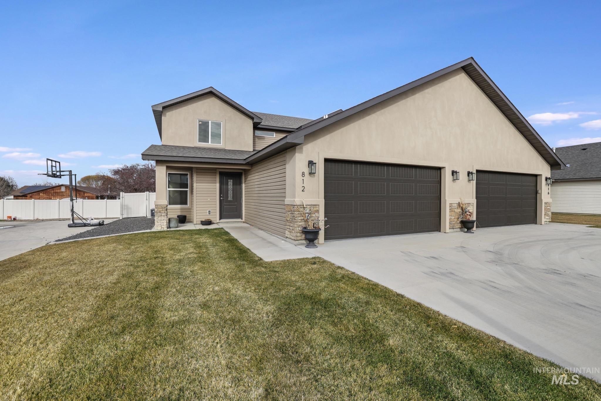 812 Jack Avenue Jerome, ID 83338 - Photo 1 of 38 View of front of house featuring a shingled roof, stone siding, stucco siding, and concrete driveway