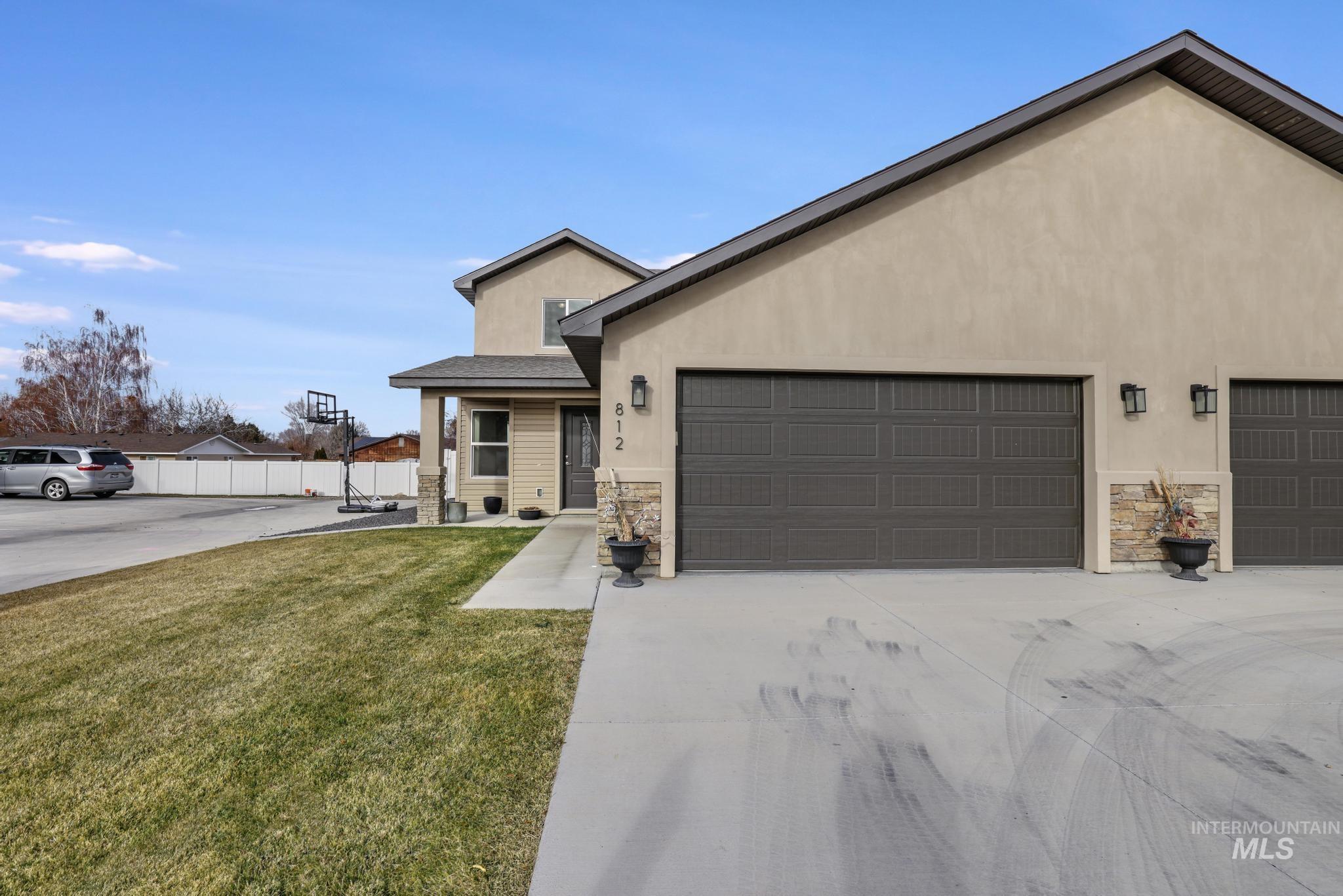 812 Jack Avenue Jerome, ID 83338 - Photo 2 of 38 View of front of property with stone siding, stucco siding, driveway, and a garage