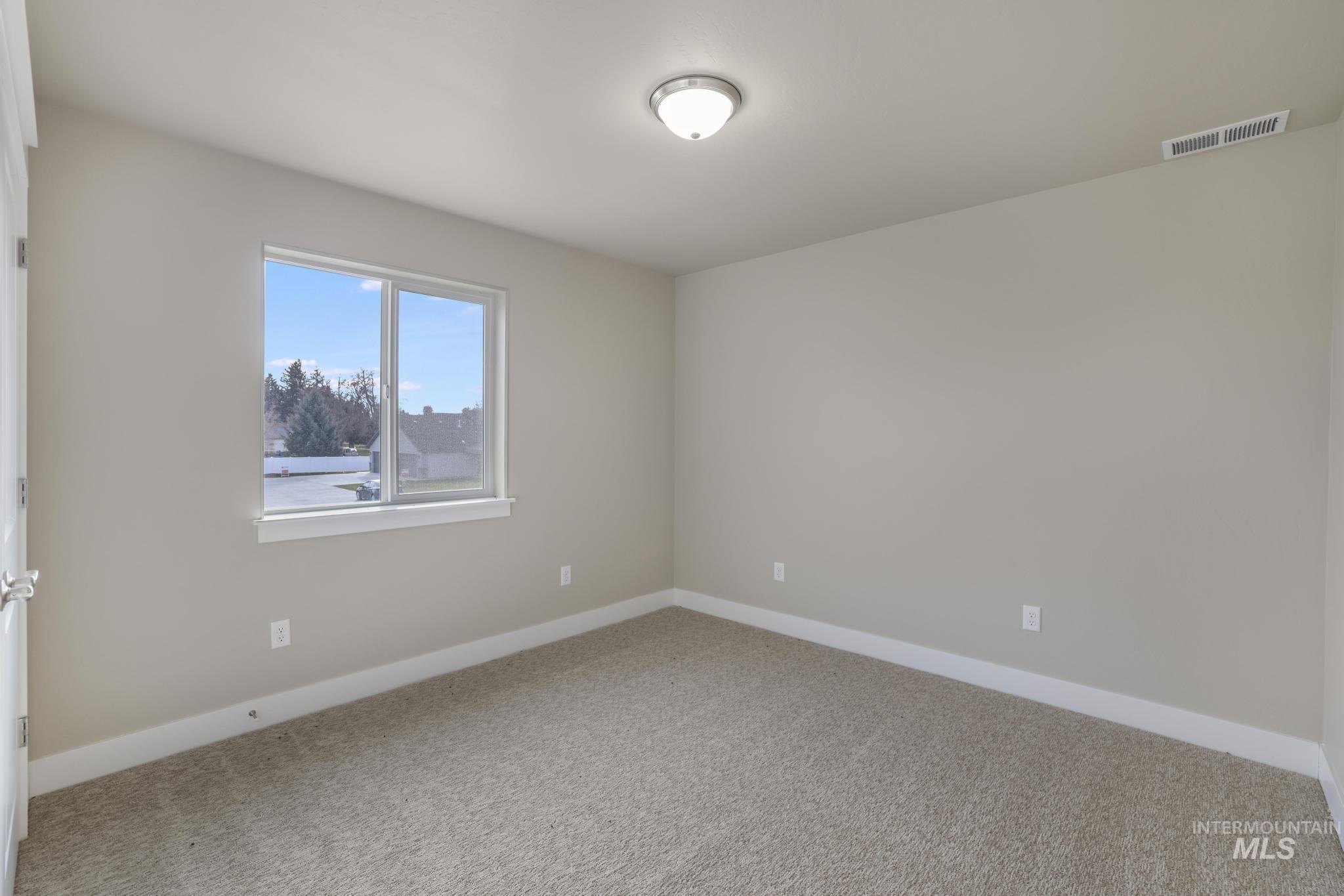 812 Jack Avenue Jerome, ID 83338 - Photo 25 of 38 Unfurnished room featuring baseboards and carpet