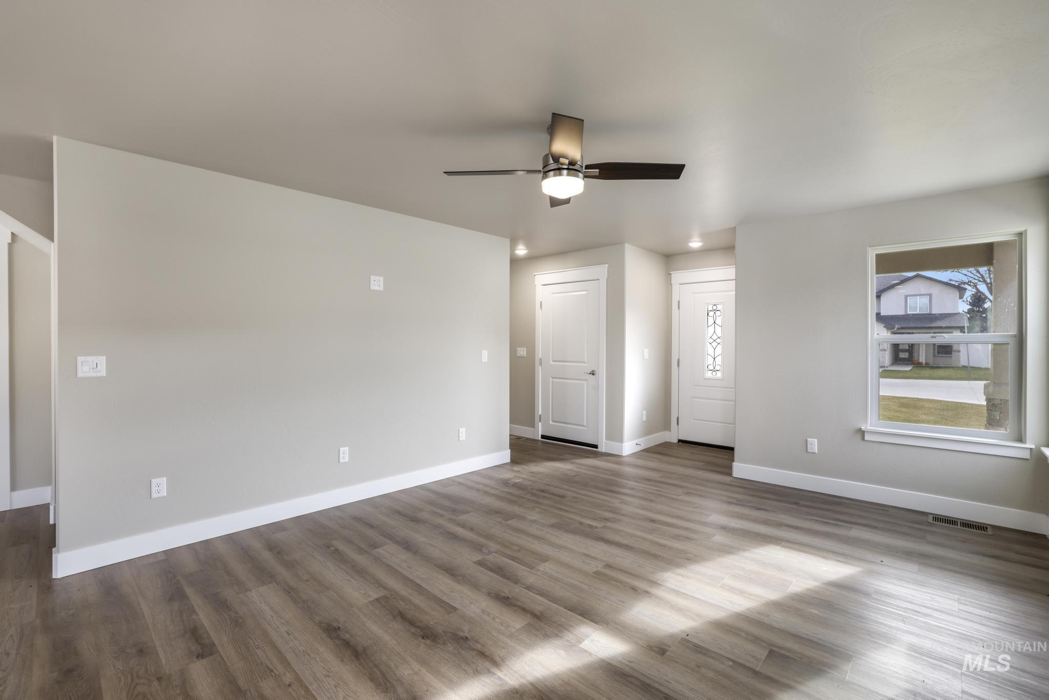 812 Jack Avenue Jerome, ID 83338 - Photo 6 of 38 Empty room featuring wood finished floors and ceiling fan