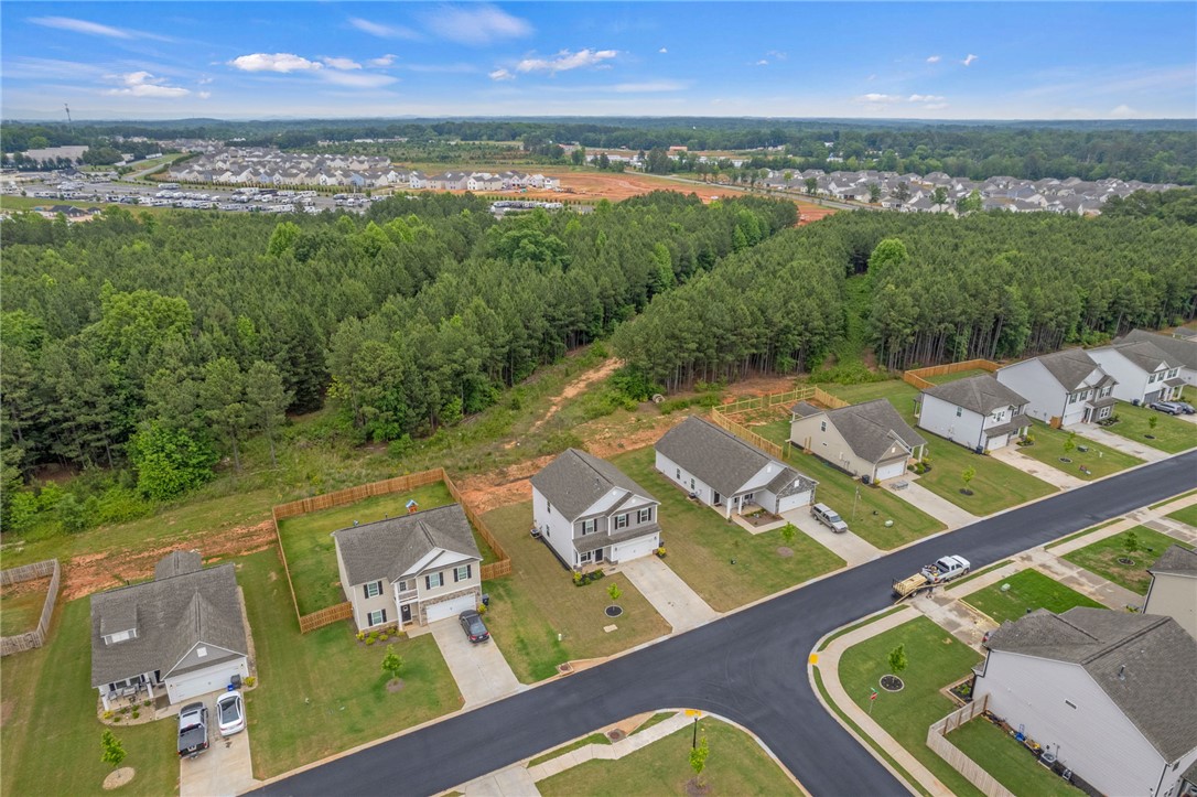 122 Bellflower Lane Anderson, SC 29625 - Photo 11 of 15 An aerial view showcases a residential community nestled beside a lush expanse of forest.