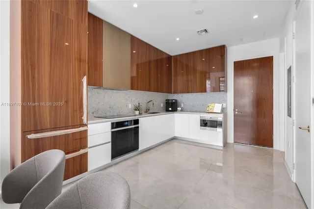a kitchen with cabinets and stainless steel appliances