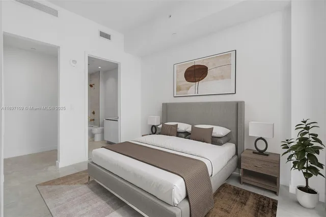 a bedroom with a bed and potted plant