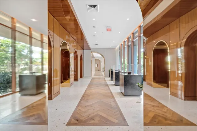 a lobby with furniture and large windows