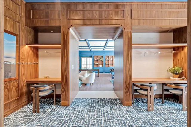 a bedroom with furniture and a large window