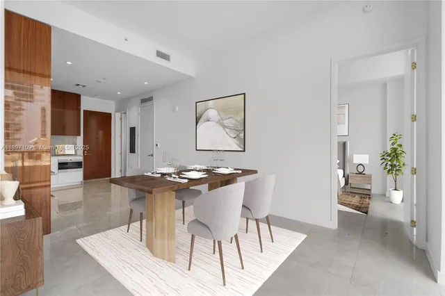 a kitchen with a table and chairs