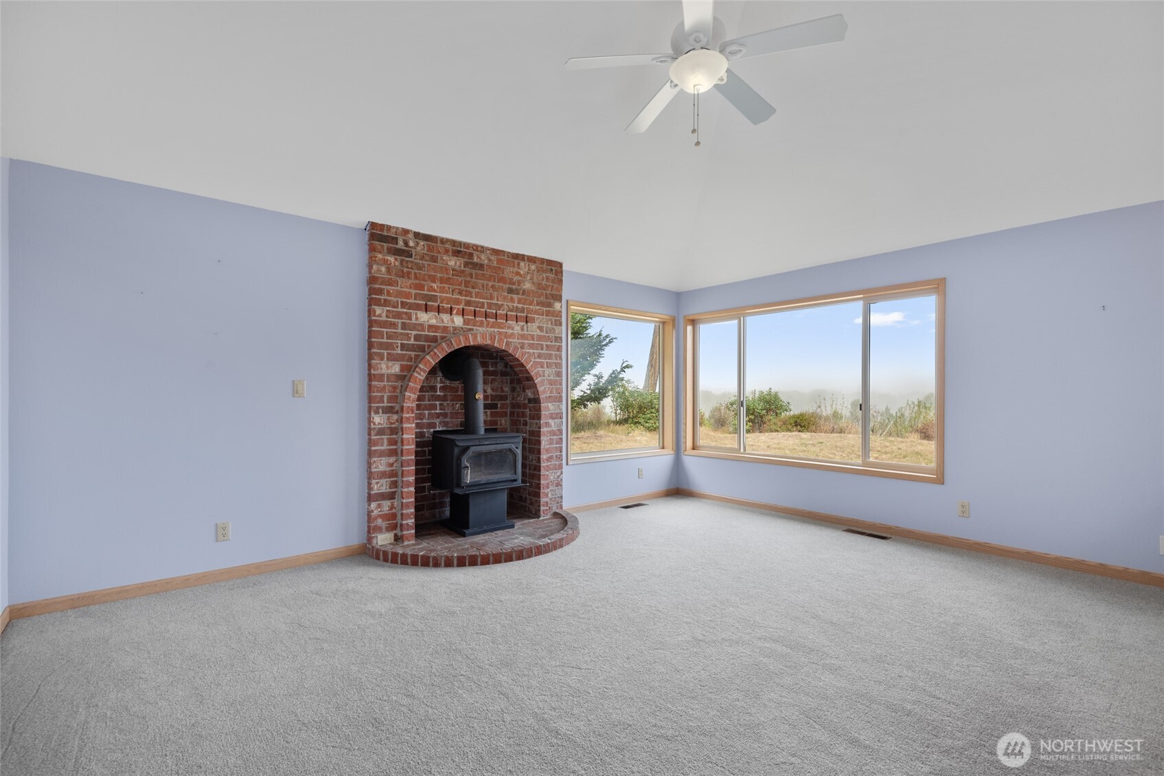 860 Hunt Road Port Angeles, WA 98363 - Photo 12 of 40 an empty room with fireplace and windows