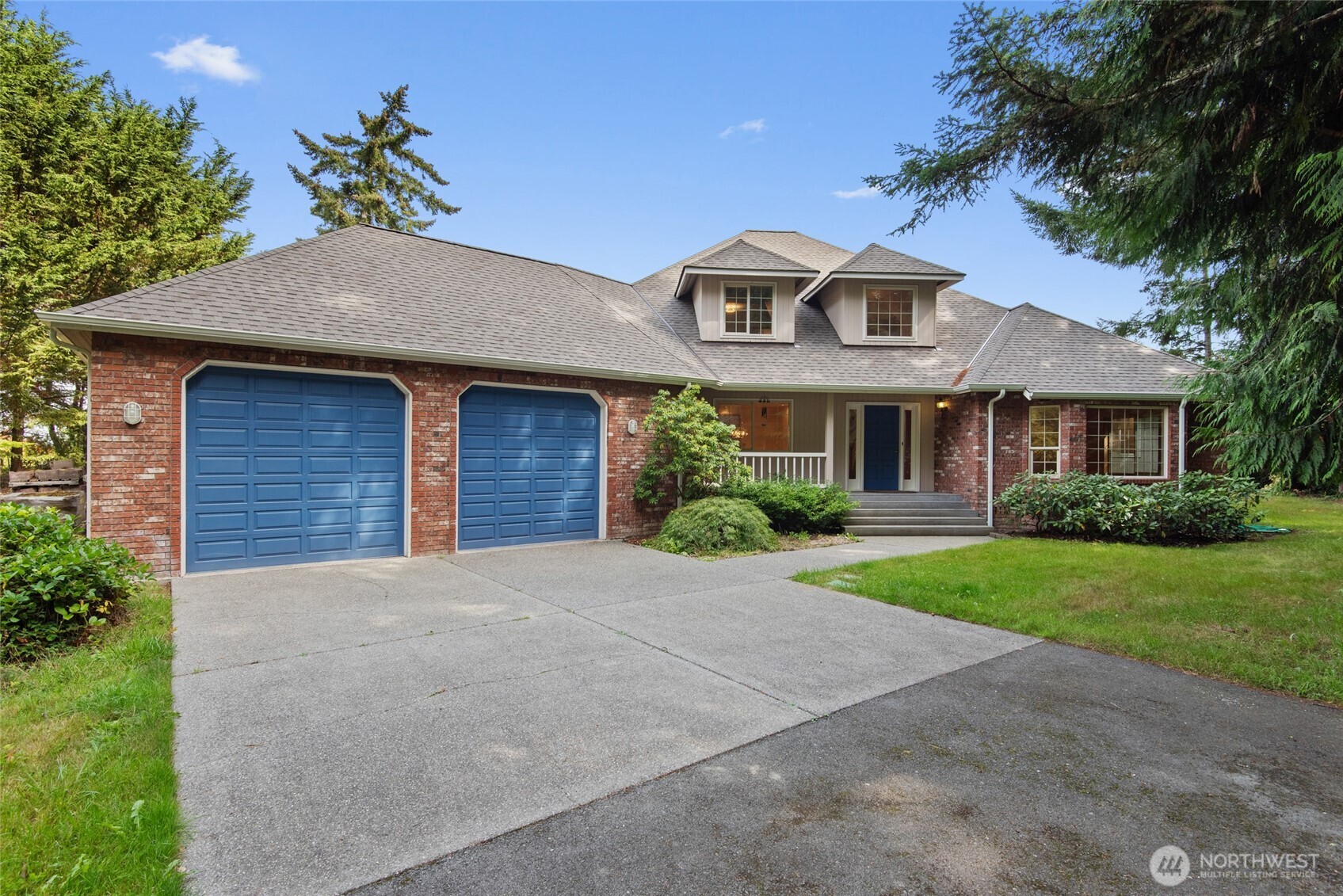 860 Hunt Road Port Angeles, WA 98363 - Photo 2 of 40 a front view of a house with a garden