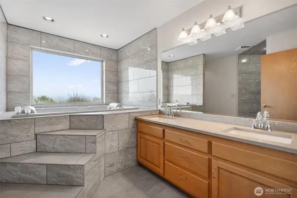 a bathroom with a double vanity sink and a mirror