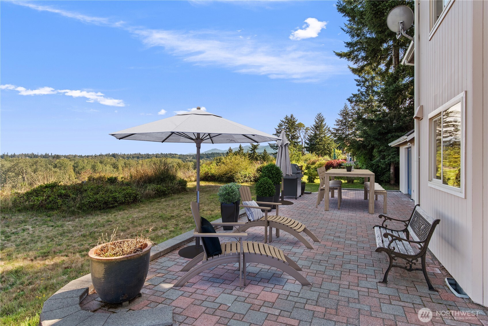 860 Hunt Road Port Angeles, WA 98363 - Photo 3 of 40 a view of a patio with a table and chairs under an umbrella