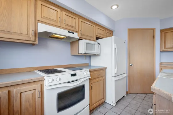 a kitchen with stainless steel appliances granite countertop a washer and dryer