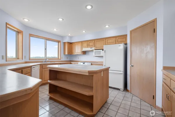 a kitchen with a refrigerator a sink and cabinets