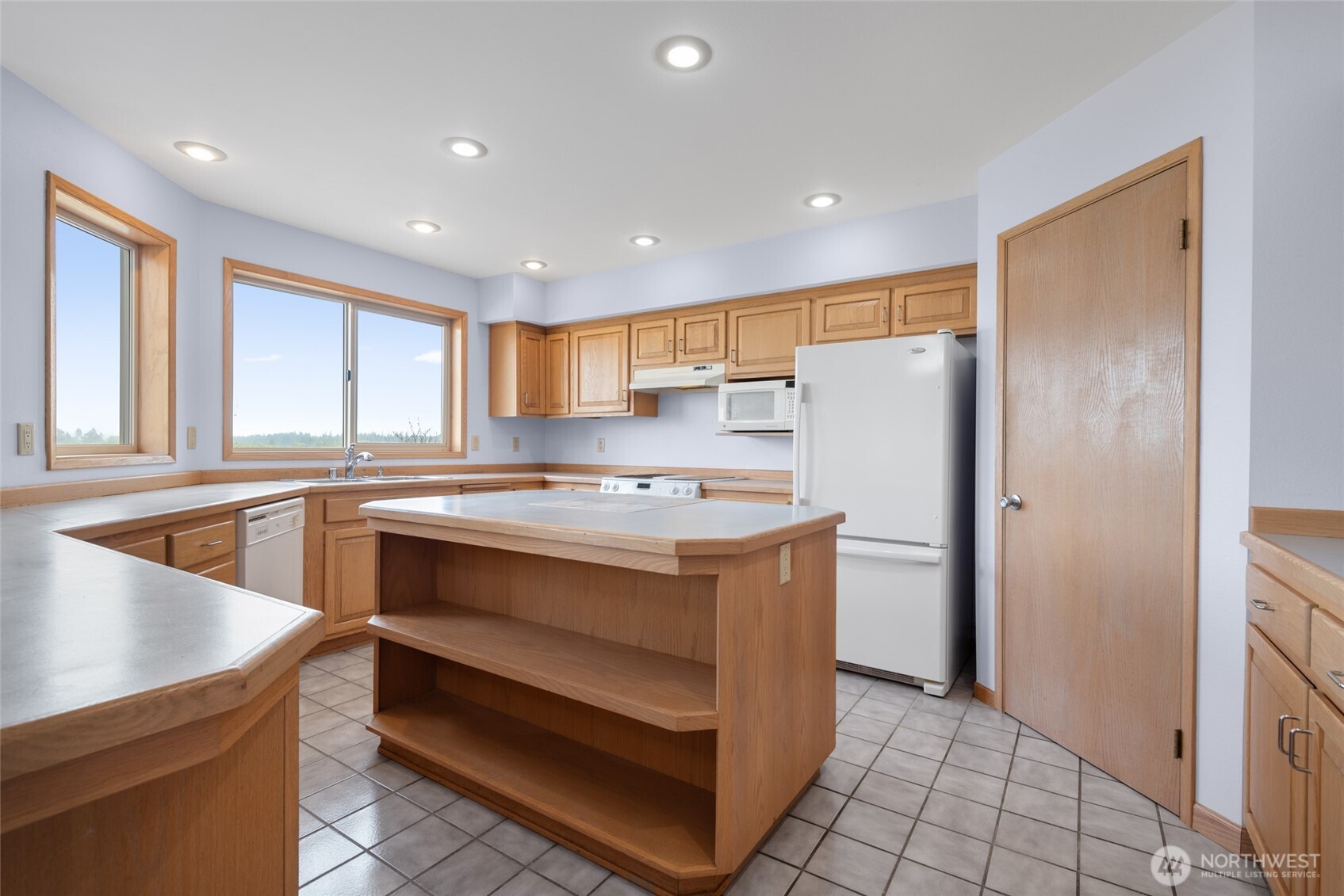 860 Hunt Road Port Angeles, WA 98363 - Photo 7 of 40 a kitchen with a refrigerator a sink and cabinets