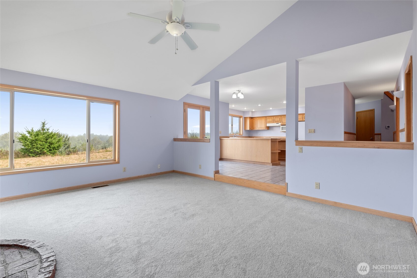 860 Hunt Road Port Angeles, WA 98363 - Photo 10 of 40 an empty room with a kitchen and windows
