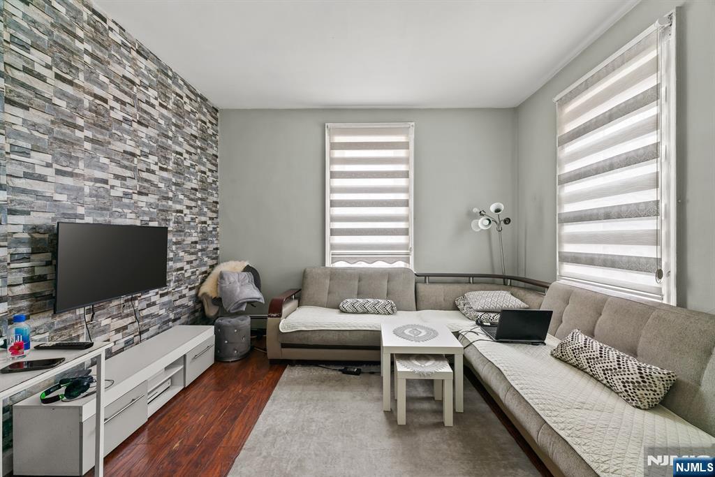 94 Center Street Clifton, NJ 07011 - Photo 17 of 38 a living room with furniture and a flat screen tv