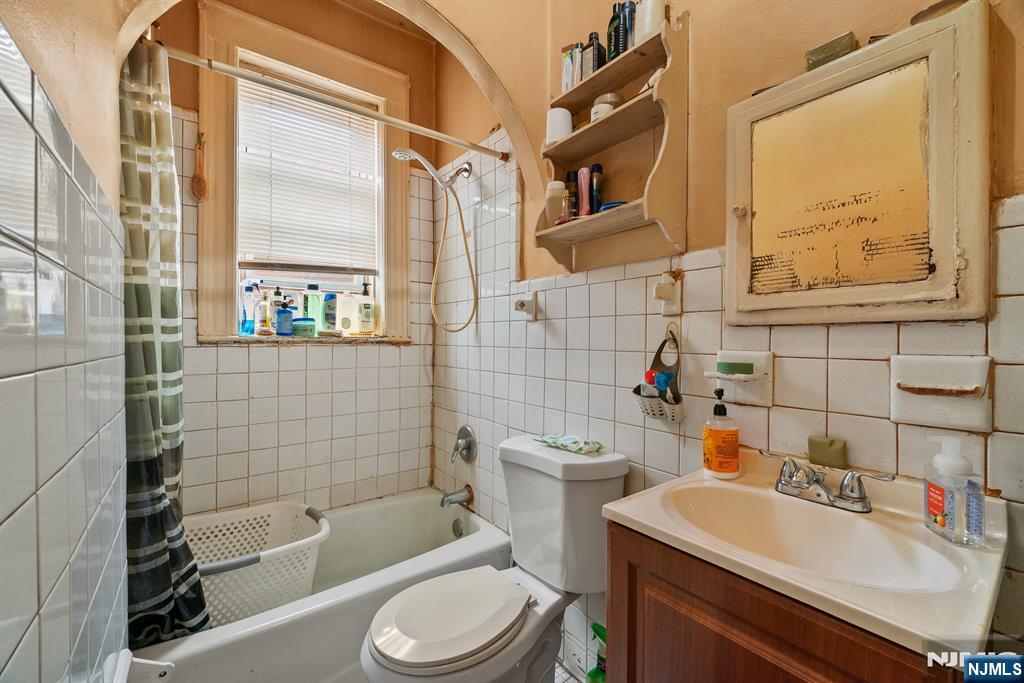 94 Center Street Clifton, NJ 07011 - Photo 18 of 38 a bathroom with a sink toilet tub and shower