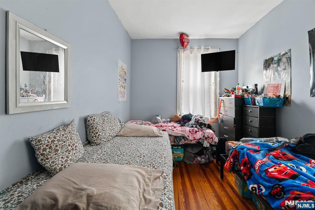 94 Center Street Clifton, NJ 07011 - Photo 26 of 38 a bedroom that has a bed and a television