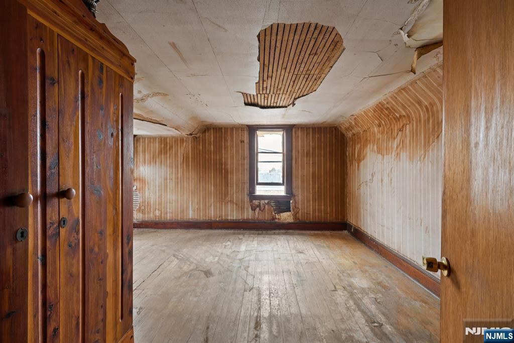 94 Center Street Clifton, NJ 07011 - Photo 36 of 38 a view of empty room with wooden floor and fan