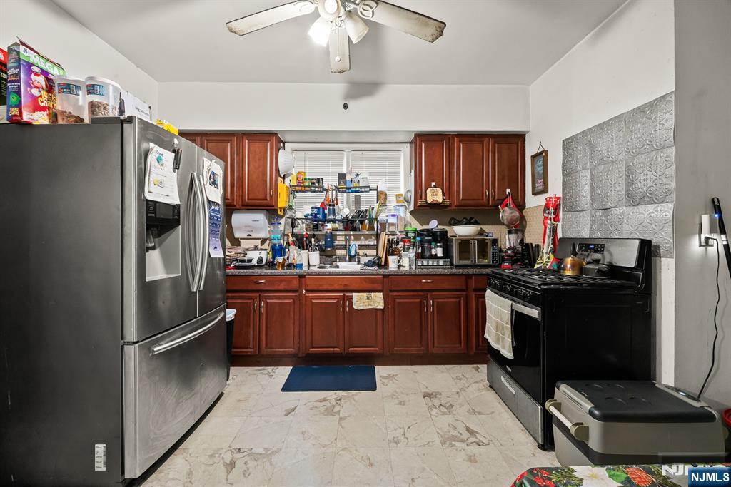 94 Center Street Clifton, NJ 07011 - Photo 6 of 38 a kitchen with stainless steel appliances granite countertop a refrigerator a stove a sink and dishwasher