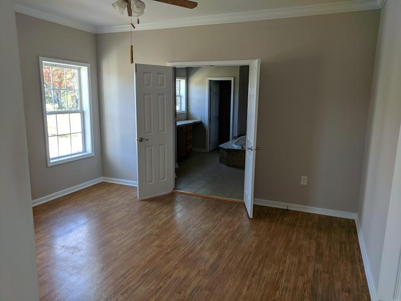 263 Elora Road Elora, TN 37328 - Photo 7 of 16 an empty room with wooden floor and windows