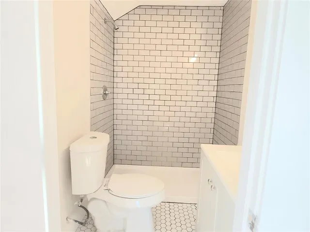 a bathroom with a toilet and a shower