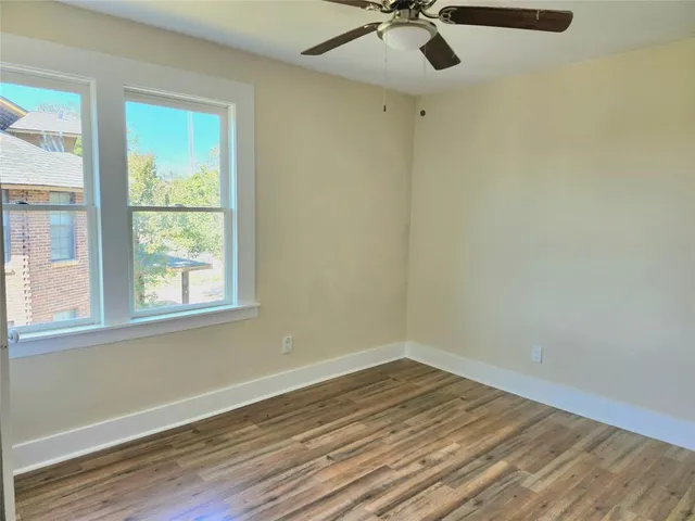 a view of a livingroom with wooden floor and a window