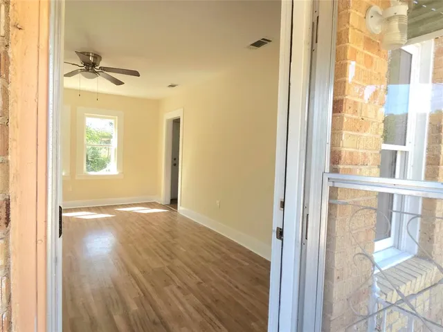 an empty room and a window with wooden floor