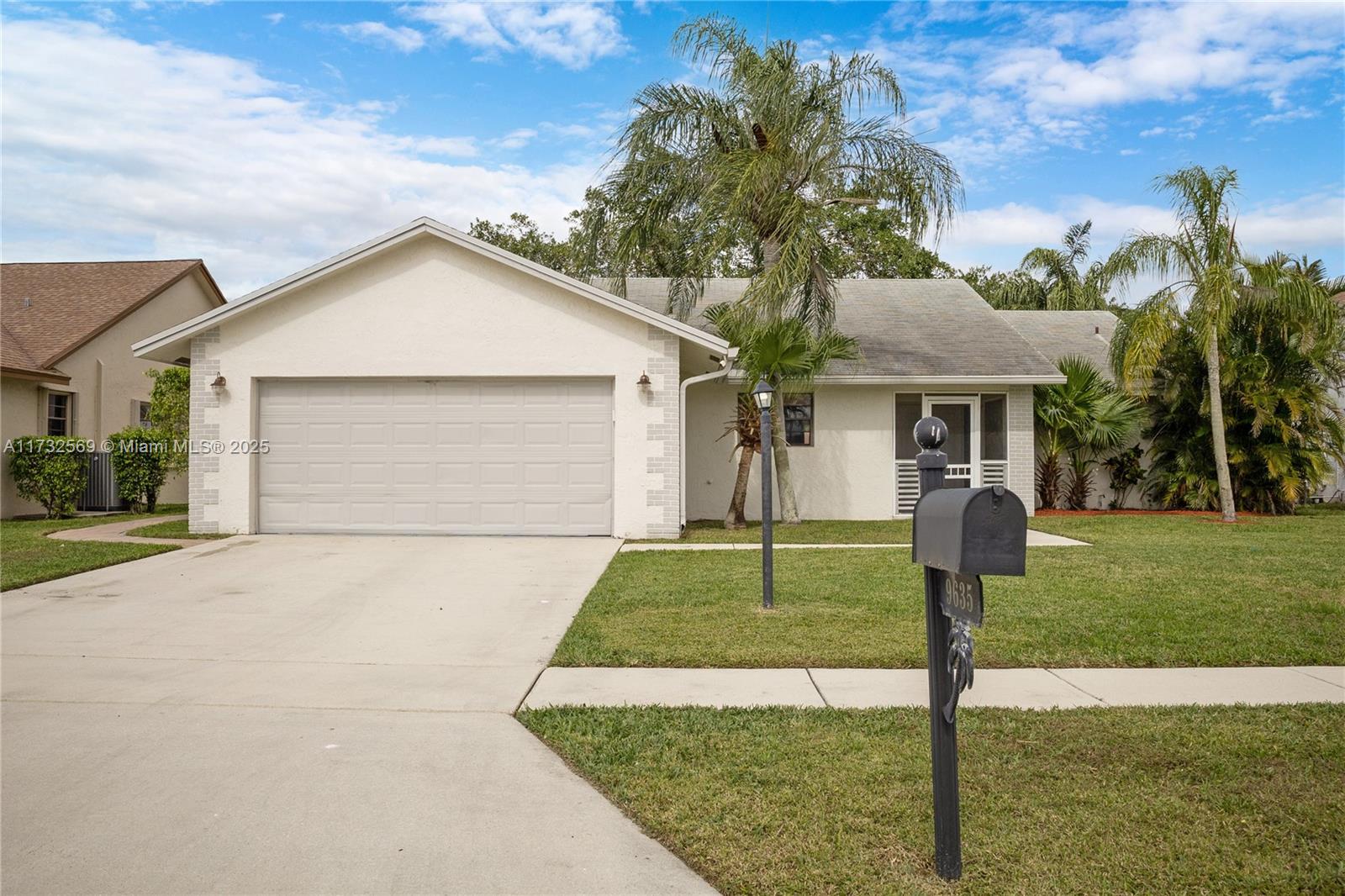 9635 Triton Court Boca Raton, FL 33434 - Photo 1 of 18 a front view of a house with garden
