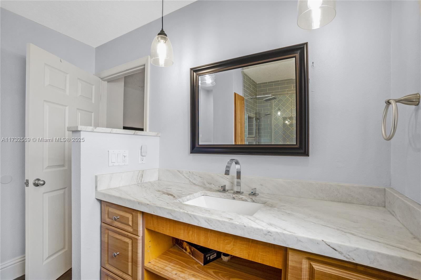 9635 Triton Court Boca Raton, FL 33434 - Photo 13 of 18 a bathroom with a sink and a mirror