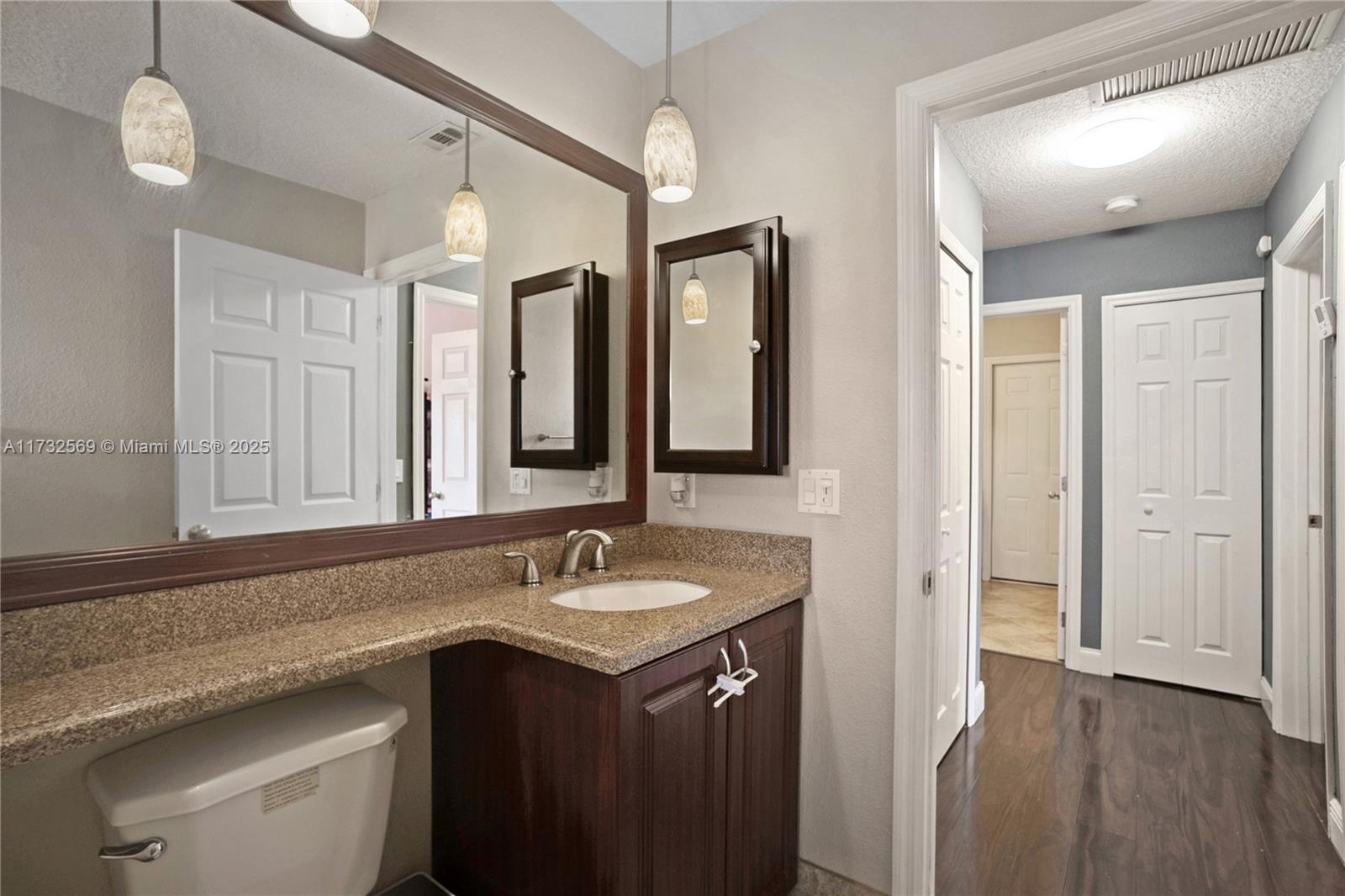 9635 Triton Court Boca Raton, FL 33434 - Photo 14 of 18 a bathroom with a sink vanity and a mirror