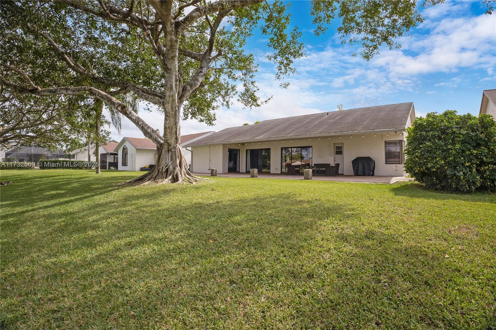 9635 Triton Court Boca Raton, FL 33434 - Photo 17 of 18 a front view of house with yard and green space