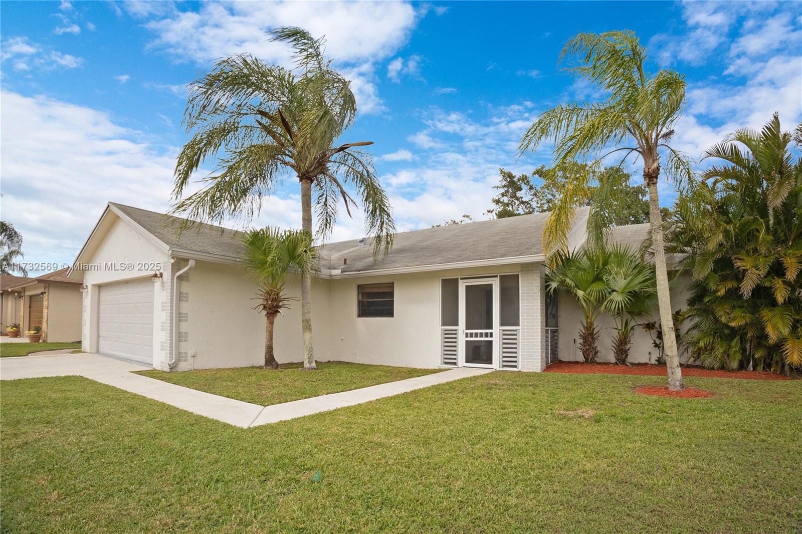 9635 Triton Court Boca Raton, FL 33434 - Photo 2 of 18 a house that has a tree in it