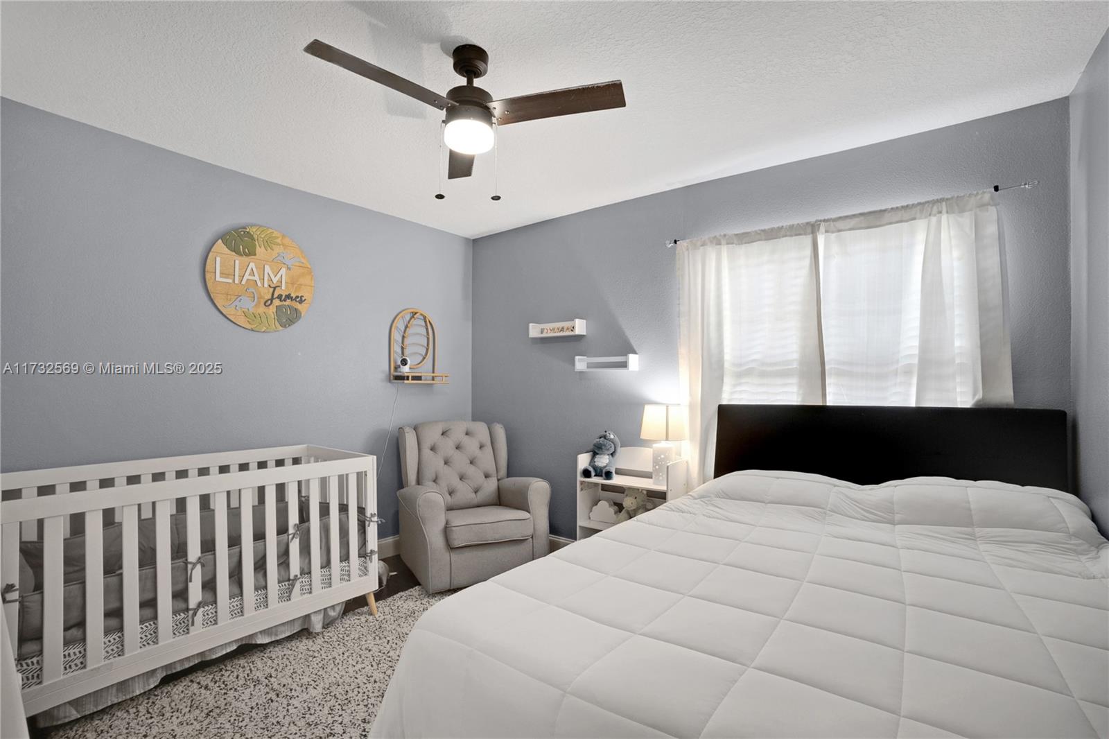 9635 Triton Court Boca Raton, FL 33434 - Photo 10 of 18 a bedroom with a large bed and a window