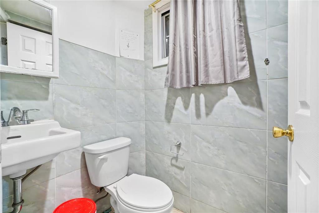 3022 Brighton 5th Street Brooklyn, NY 11235 - Photo 2 of 4 a white toilet sitting next to a bathroom sink