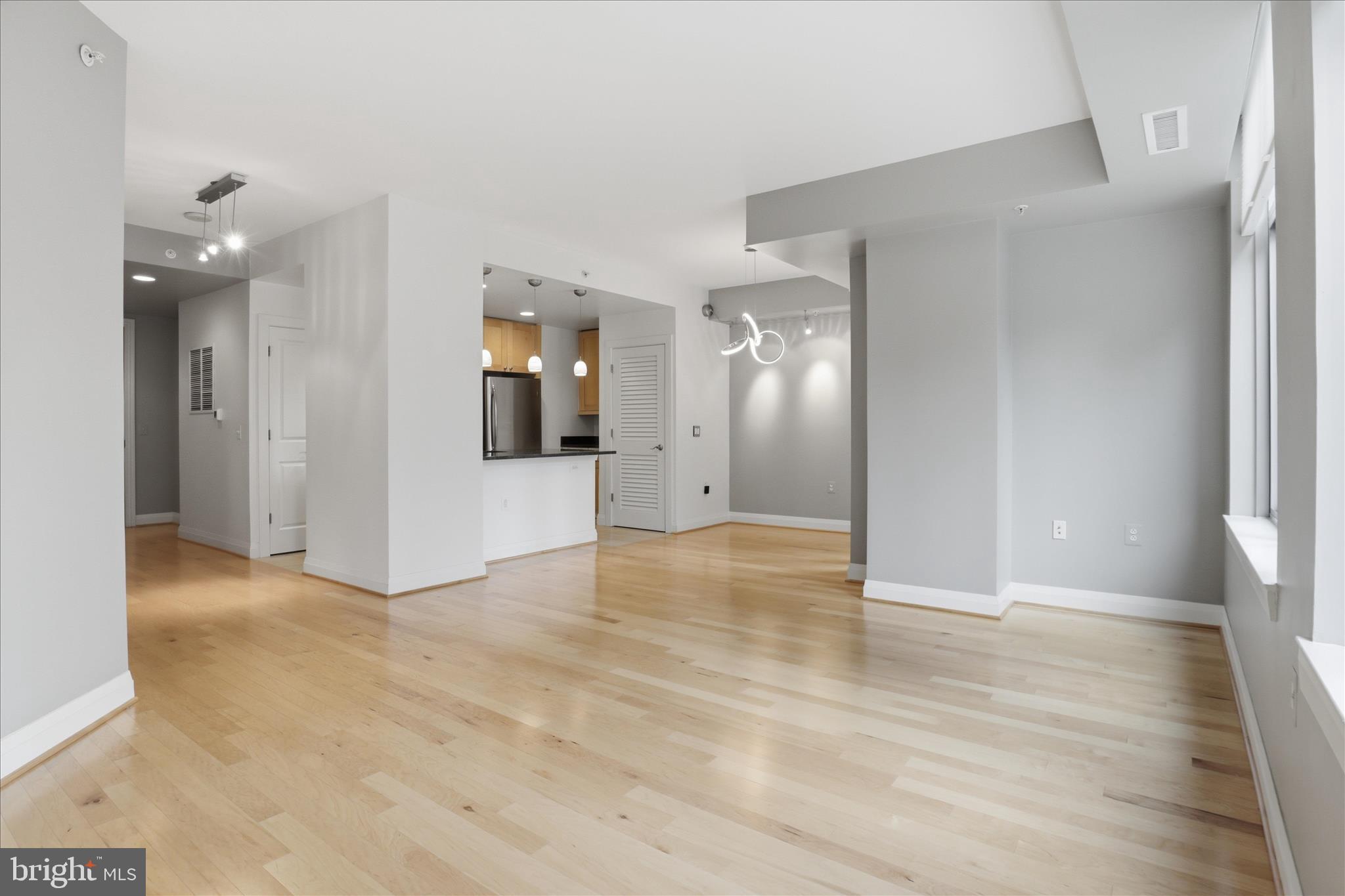 11990 Market Street, Unit 216 Reston, VA 20190 - Photo 17 of 41 a view of a big room with wooden floor and a bathroom
