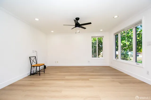 a view of a livingroom with a hardwood floor and a ceiling fan