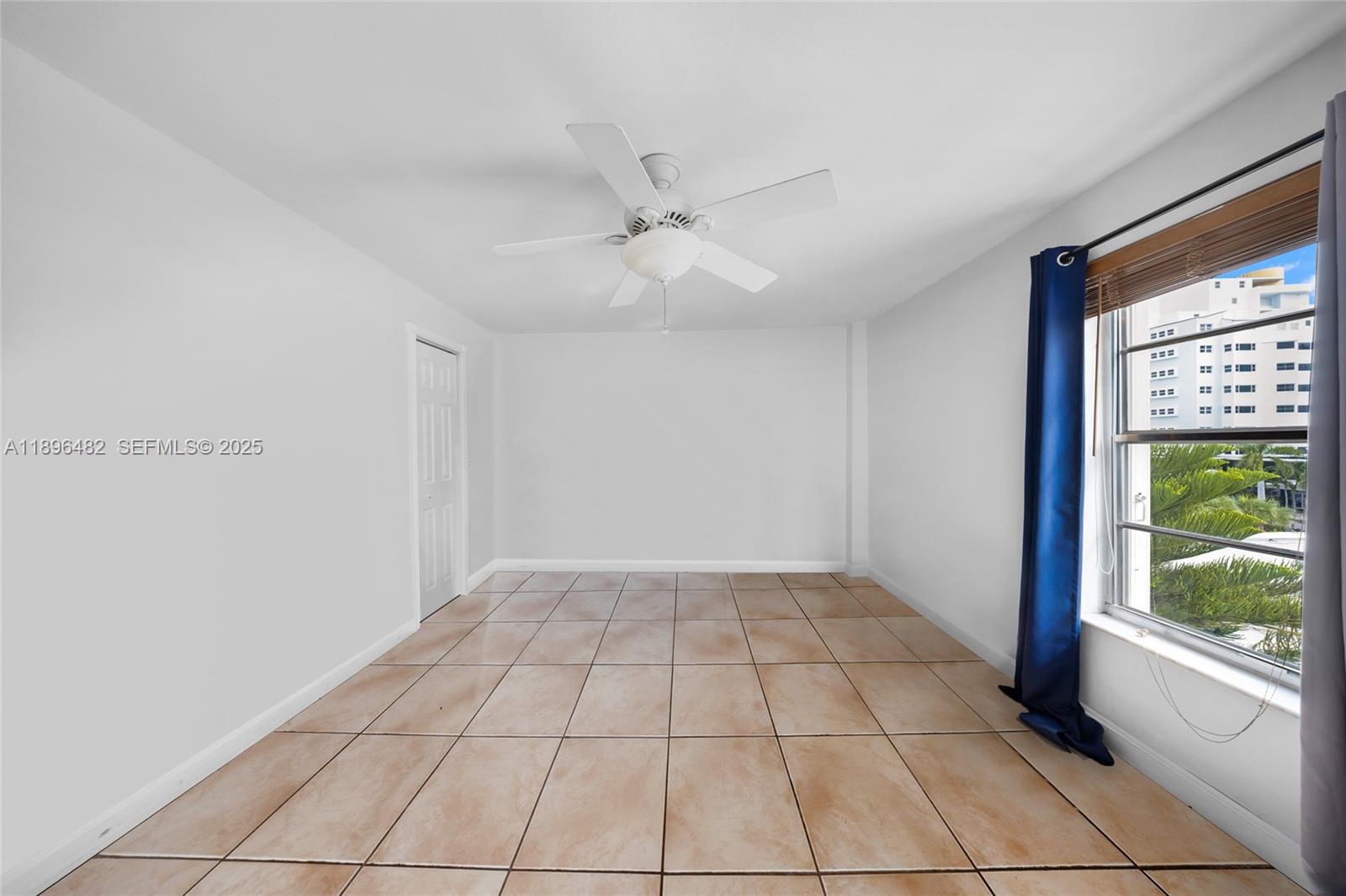 6545 Indian Creek Drive, Unit 504 Miami Beach, FL 33141 - Photo 15 of 38 wooden floor in an empty room with a window
