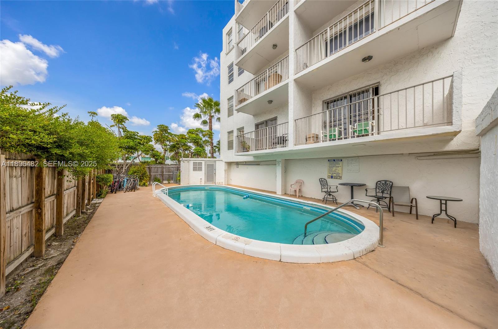 6545 Indian Creek Drive, Unit 504 Miami Beach, FL 33141 - Photo 25 of 38 a view of a swimming pool with potted plants